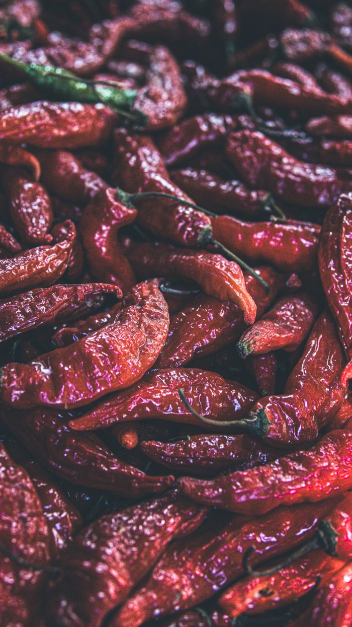 Vibrant close-up of fresh red chili peppers highlighting texture and color.